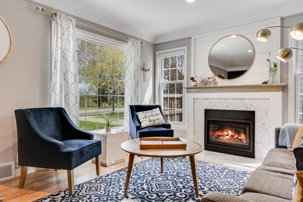 Relax in your elegant living space with plush seating and a cozy fireplace creating the perfect ambiance.