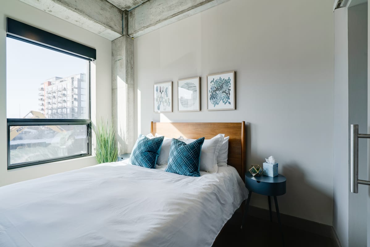 Wake up refreshed in your modern bedroom, where industrial charm meets contemporary comfort with crisp linens and stunning city views.