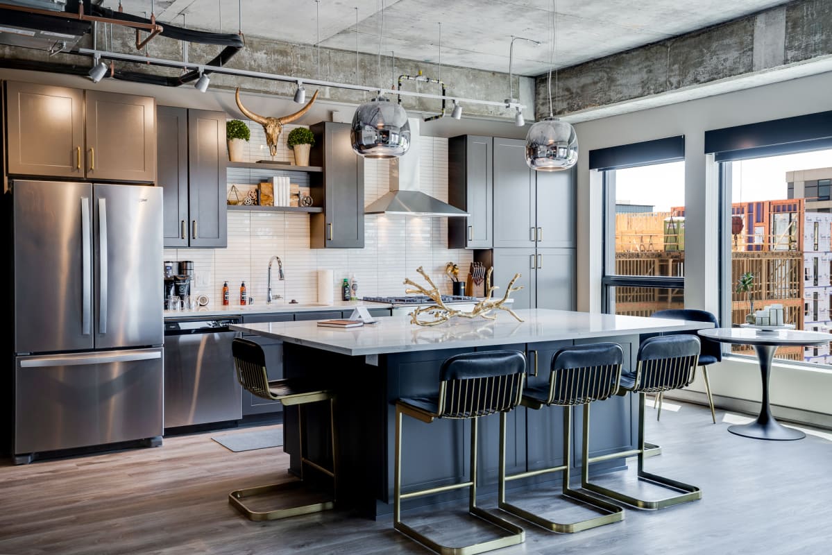 Your modern kitchen showcases sleek gray cabinetry, quartz countertops, and premium stainless steel appliances—perfect for creating memorable meals during your stay.