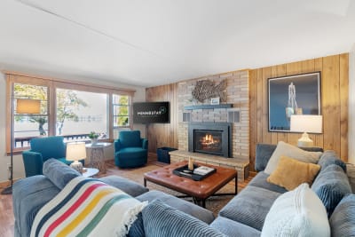 Cozy living room with lake view, fireplace, and comfortable seating.