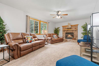 Inviting living room with brown leather recliners, a fireplace, and stylish decor.