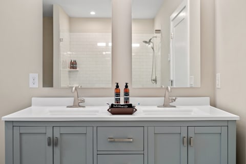 Modern bathroom interior featuring a double sink vanity and a spacious shower.