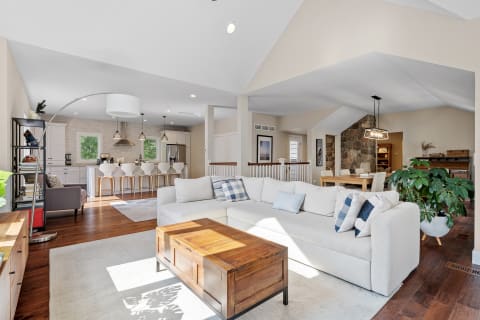 Open living room and kitchen with modern design elements and natural lighting.