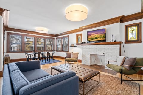 Cozy living room with modern furniture, large windows, and a stylish coffee table.