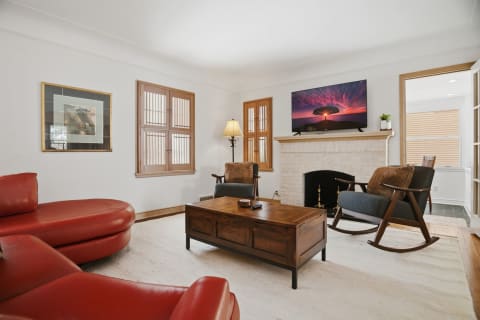 Inviting living room with leather seating, fireplace, and entertainment center.