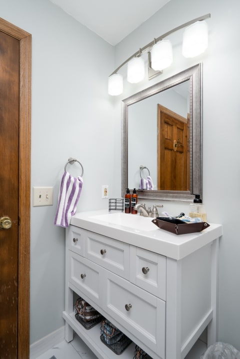 Contemporary bathroom featuring a white vanity and striped towel.