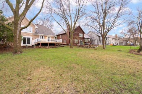 A view of several residential homes and green lawns in a suburban neighborhood.