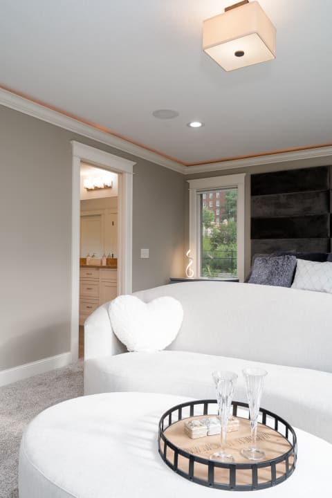 Cozy living room featuring a gray sofa with heart-shaped pillow and a stylish coffee table.