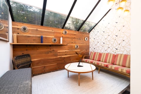 Cozy living area with wooden walls, contemporary accents, and stylish furniture.