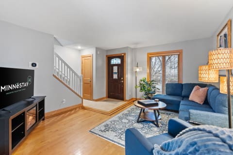 Living room featuring a blue couch, coffee table, and decorative elements.
