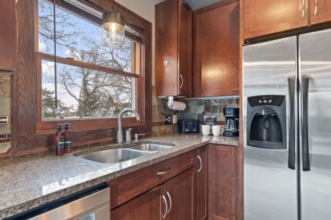 Cozy kitchen with wood cabinets and stainless steel appliances.