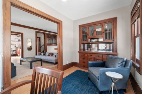 Cozy interior space with vintage wooden furniture and modern seating.