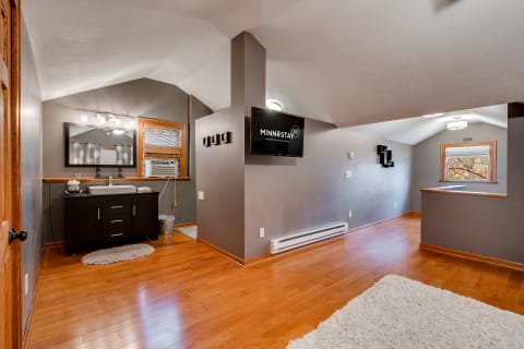 Interior view of a modern rental space with wooden floors and gray walls.