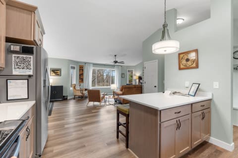 Interior view of a modern kitchen and living room with natural light.