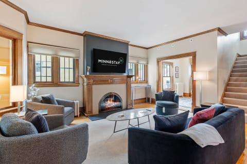 A cozy living room featuring plush seating and a fireplace, enhancing the inviting atmosphere.