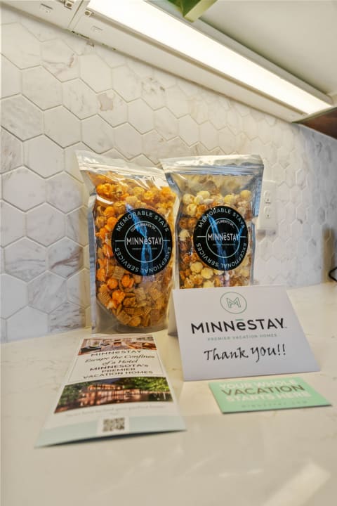 Two bags of popcorn and a thank you note on a kitchen counter.