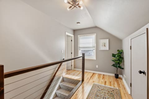 Contemporary stairs landing with wooden flooring and modern decor.