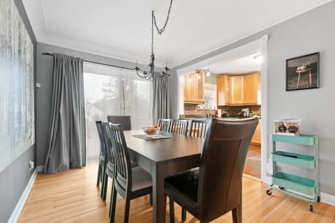 Stylish dining room featuring a dark wood table and modern decor.