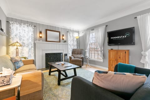 Cozy living room with a couch, recliner, coffee table, and decorative fireplace.