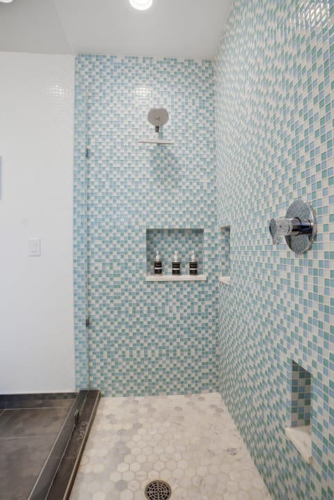 Modern shower with mosaic tiles and luxury amenities