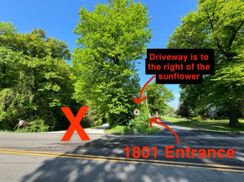 Intersection showing the 1801 Entrance with a sunflower sign and a deer leaping in the background.