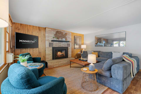 Comfortable living room featuring a sectional sofa, decorative fireplace, and modern accents.