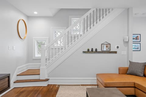 Stylish staircase and cozy seating area in a contemporary interior space.