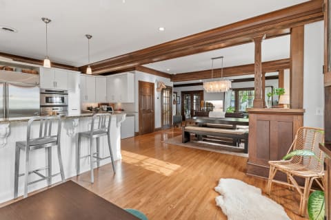 A spacious and modern kitchen with stainless steel appliances and a stylish living area in an open-concept layout.