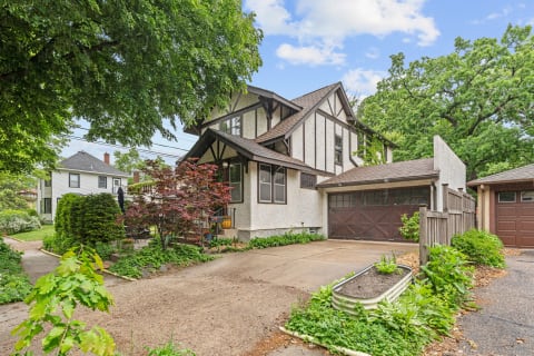 Tudor-style house with a garden and driveway.