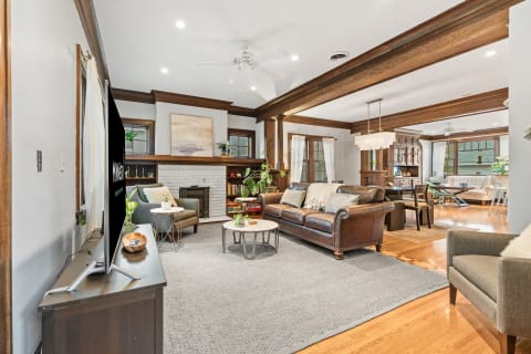 Stylish living room with leather sofa, armchair, and fireplace.
