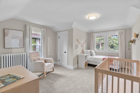 Cozy and calming nursery with comfortable rocking chair and wooden crib.