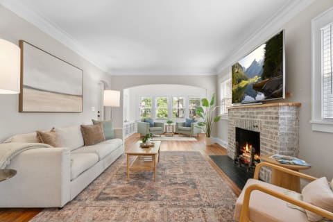 Inviting living room with a light sofa, coffee table, and fireplace.