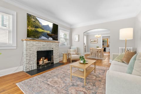Living room with a fireplace and flat-screen TV, designed for comfort and style.