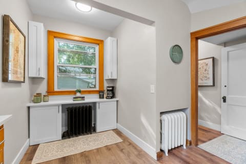 Bright corner of a home featuring a window, countertop, and decorative items.