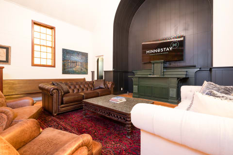 Stylish living room with leather seating, art, and a wooden coffee table.