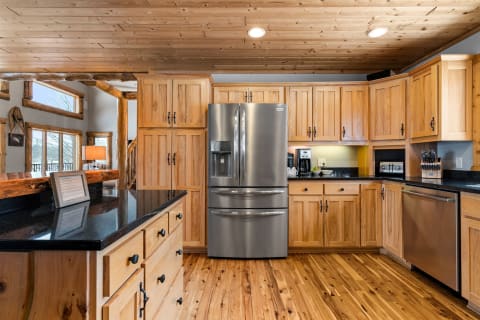 Modern kitchen featuring wooden cabinets and a stainless steel refrigerator.