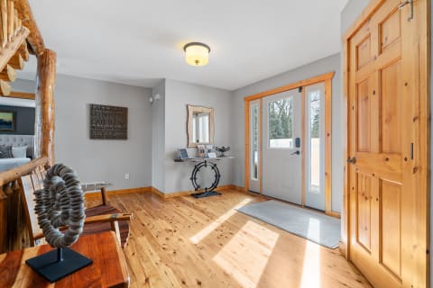 Cozy entrance hall with wooden accents and natural light.