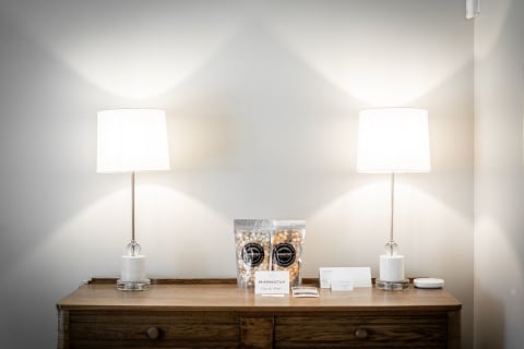Cozy dresser with lamps and popcorn bags under soft light.