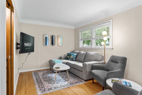 A cozy living room with a gray sofa, decorative pillows, and modern accents.