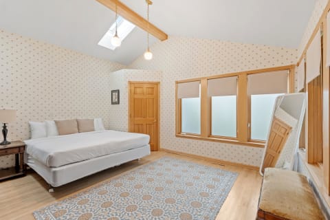 Comfortable bedroom with a bed, nightstand, and stylish decor.