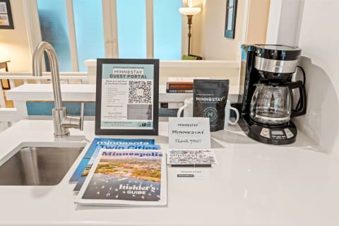 Kitchen countertop with Minnestay guest information, brochures, and coffee maker.