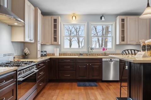 Inside view of a modern kitchen with a gas range and sleek cabinetry.