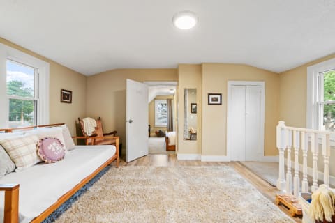 Cozy room with daybed, rocking chair, and warm beige walls.