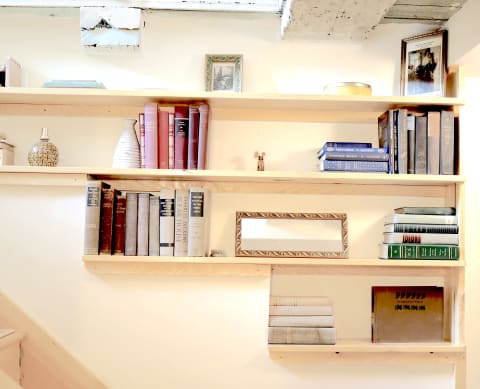 Neatly arranged wooden bookshelf with various books and decorative pieces.