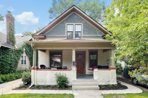 Front view of a charming bungalow house with a porch.