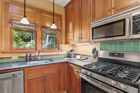 Cozy kitchen with wooden cabinets and stainless steel appliances.