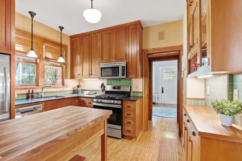 Cozy kitchen featuring wooden cabinets, granite countertops, and stainless steel appliances.