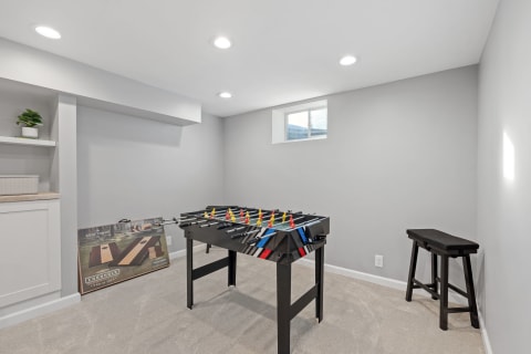 Interior view of a cozy game room with a foosball table and natural light.