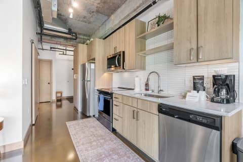 Contemporary kitchen with wooden cabinets and modern appliances.