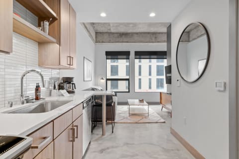 Interior view of a contemporary studio apartment featuring a kitchen and living space.